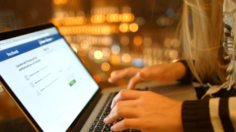 The girl  on the laptop is gaining a password, register to log into Facebook. 4K Video stock 59373959