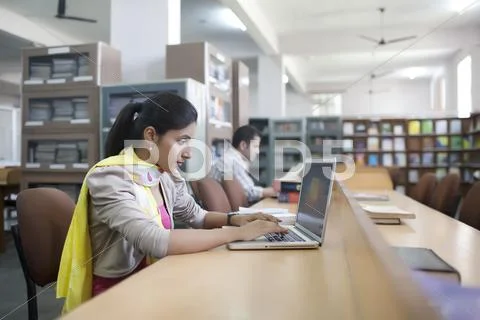 Girl With Laptop In Library