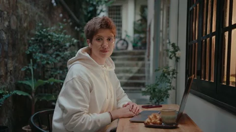 Girl with Laptop Posing on Camera in a Small Patio Stock Footage 237350281