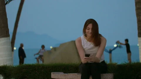 Girl laughing, using smartphone device 動画素材 62869393