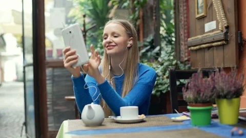 Girl laughing while watching something funny on tablet Stock Footage 70447168
