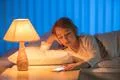 The girl lay on the bed and phone. Evening night time Photo