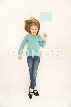 The girl lay on floor near the dialog sign. View from above Stock Photos