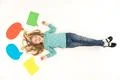 The girl lay on the floor near the dialog signs. View from above Photo