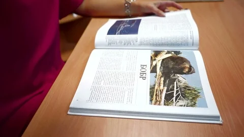 Girl leafing through a book  Stock Footage 77347848