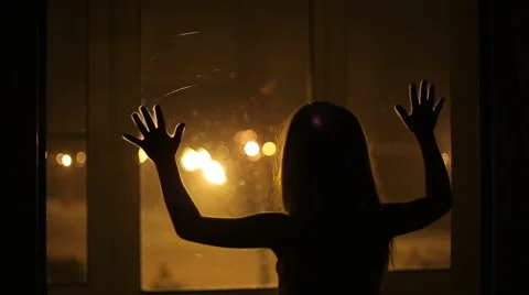 The girl leaned against the window Stock Footage 42878981