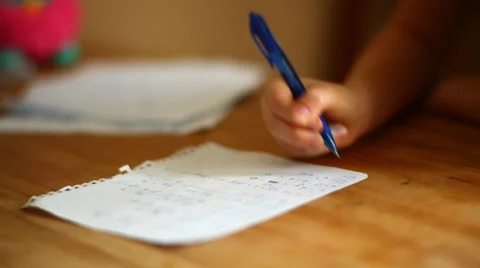 Girl learning math at home, hands holding a pen close-up Stock Footage 34217624