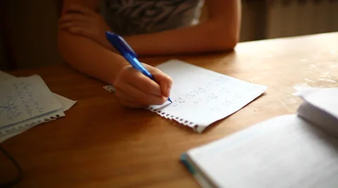 Girl learning math at home, hands holding a pen close-up, with soft focus Stock Footage 34217663