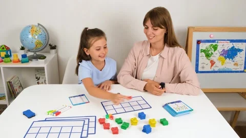 Girl Learning Math with Teacher and Fun Bear Counters Stock Footage 295001569