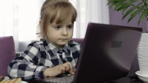 Girl learning online lessons using digital laptop computer. Distance education Foto stock