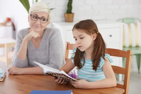 Girl learning reading with tutor Foto stock