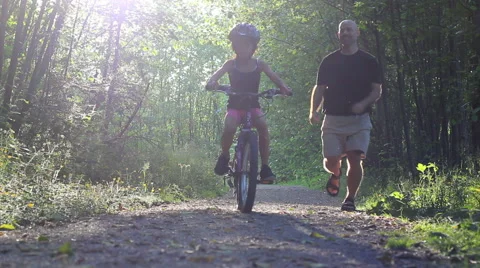 Girl Learning To Ride Bike On Forest Path Stock Footage