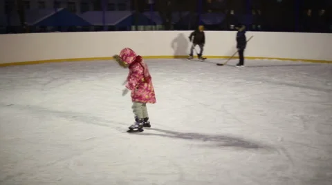 Girl learning to skate and falls on the ice Stock Footage 59142592