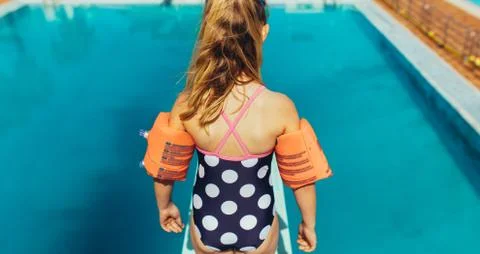 Girl learning spring board diving at pool Stock Photos