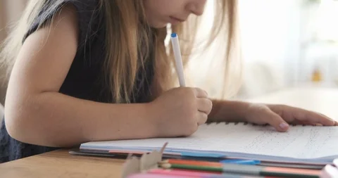Girl learning to write by doing homework Stock Footage 109367537