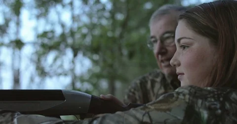 Girl learns gun and hunting safety from older man Stock Footage