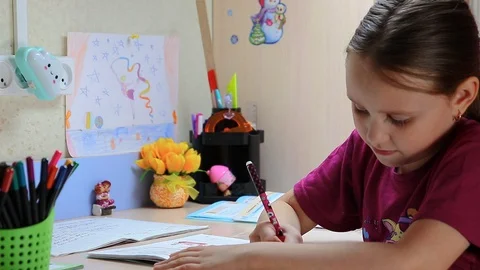 The girl learns lessons at home Stock Footage 128754657
