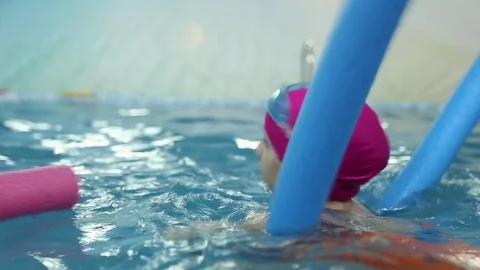 Girl learns to swim in the pool Stock Footage 70819766