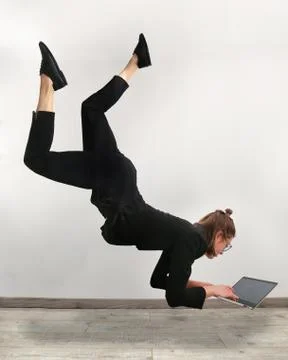 Girl levitating in front of the computer Stock Photos