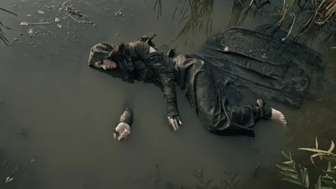 The girl lies in the water. Refugee. Apocalypse. Stock Footage 83800596