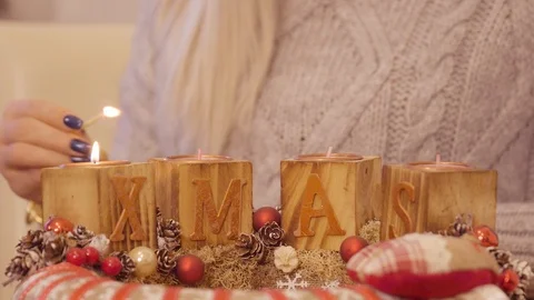 Girl lights up the second candle on advent wreath Stock Footage 99374129