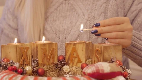 Girl lights up the third candle on advent wreath Stock Footage 99374125