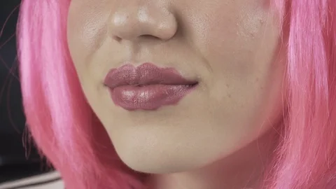 Girl with the lips of the devil. Young beautiful girl with pink hair. 库存影片 121560968