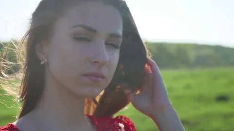 Girl lips. Girl is standing on the nature hair touch lips, lifestyle strong wind Stock Footage