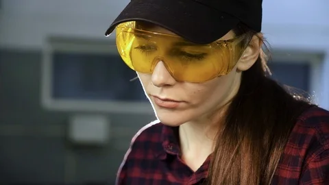 Girl locksmith in protective glasses Video stock 104077067