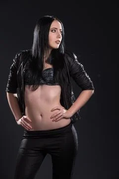 The girl with long hair on black background Stock Photos