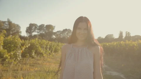 Girl with long hair walking along the rows of vineyards Stock Footage 59383962