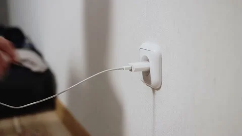 Girl with long nails inserts and takes out a charger. Stock Footage 145553524