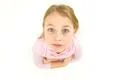 The girl look to the camera on the white background. View from above Photo