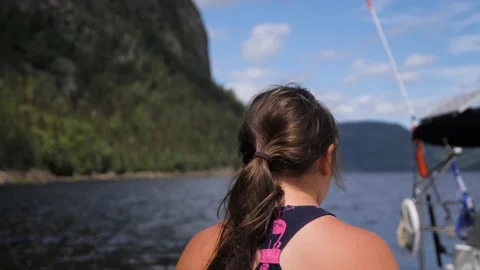 Girl looking at a beautiful landscape water lake valley montains boat nature Stock Footage