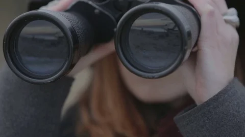 Girl is looking with binoculars Stock Footage 72557421