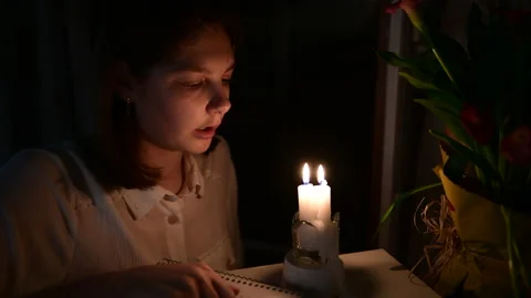 The girl looking the burning candles, blowing out the candles in the room Stock Footage 156756953