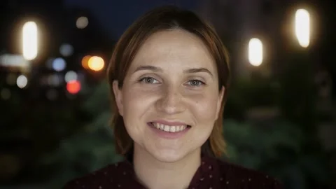 Girl looking at camera smiling standing in the city streets summer. Portrait. Stock Footage 154575595