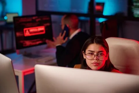 Girl Looking at Computer Screen in Red Light Foto stock