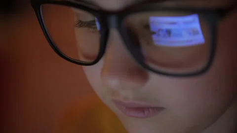 Girl is Looking at Digital Tablet Computer Screen With Glasses. Child Eyes .. Video stock 302727783