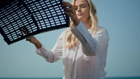 Girl looking engine breakage under car hood outdoors close up. Auto accident Stock Footage 241447384
