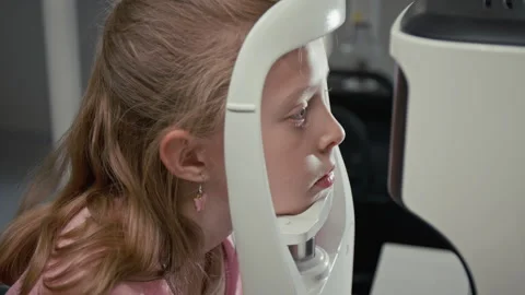 Girl Looking into Eye Diagnostic Machine Setting Head in Frame Stock Footage 322663745