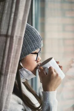Girl looking at infinity reflected in the window with mask Stock-Fotos