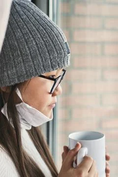 Girl looking at infinity reflected in the window with mask Stock Photos
