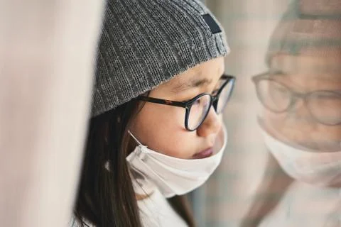 Girl looking at infinity reflected in the window with mask Stock-Fotos