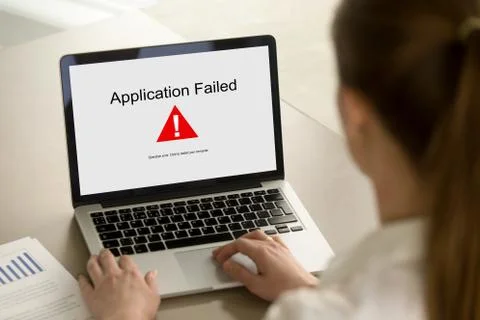Girl looking at laptop with Application Failed error on screen. Stock Photos