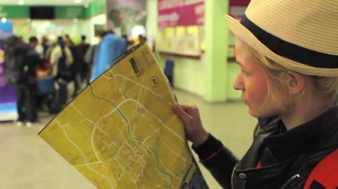 Girl looking at the map attentively Stock Footage 64207614
