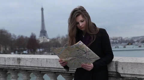 Girl looking map in Paris at the Eiffel tower Stock Footage 64054951