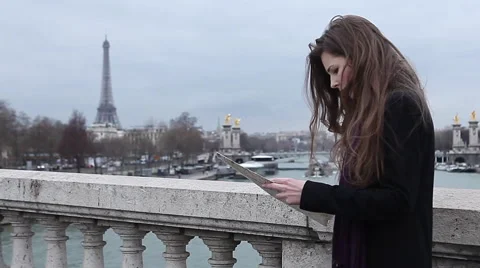 Girl looking map in Paris at the Eiffel tower Stock Footage 64054975