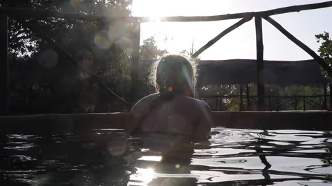 Girl looking out from pool in the sun Stock Footage 170255138