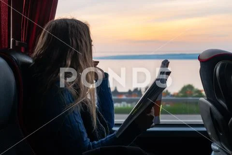 Girl Looking Out Window Reading Bus Sunset Landscape Peaceful Single Person Stock Photos